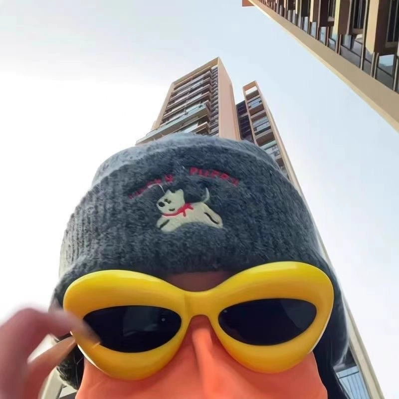 Close up view from below of duck beak mask with yellow sunglasses